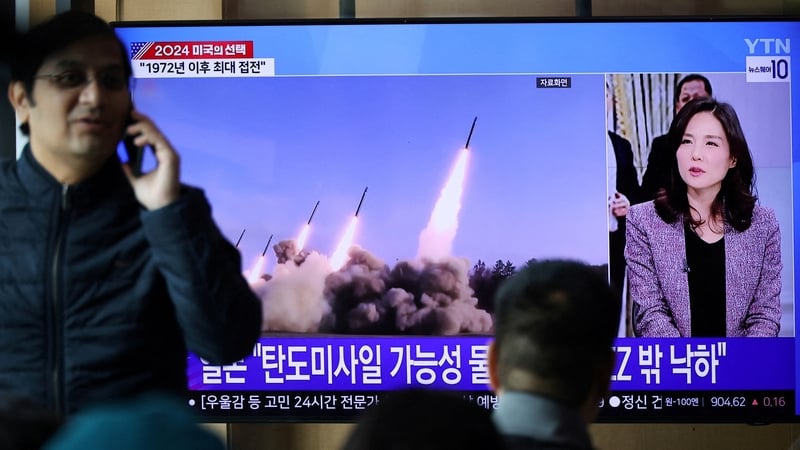 People watch a TV news report in South Korea about North Korea firing missiles that flew 400km
