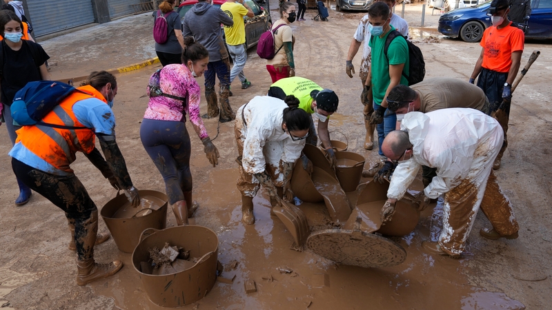 Volunteers work to clear mud filled streets in Aldaia, Valencia