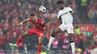 Liverpool's Cody Gakpo (L) rises with Edmond Tapsoba of Bayer 04 Leverkusen