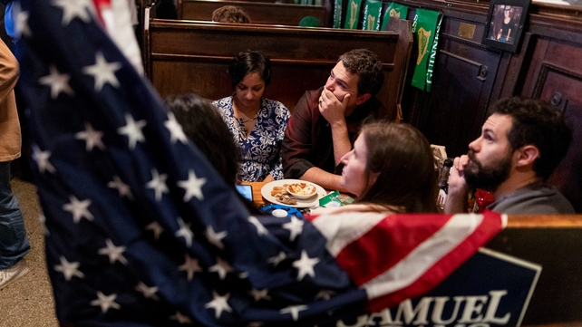 Friends watch anxiously from a bar as results came in across the states