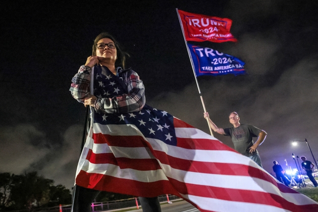 Supporters of former US president and Republican presidential candidate Donald Trump gather near his Mar-a-Lago resort in Palm Beach, Florida