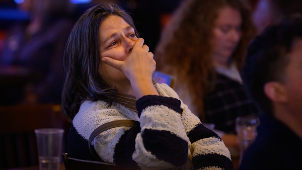 A supporter of Democratic presidential nominee, US Vice President Kamala Harris, reacts as results are displayed during a Democrats Abroad election party