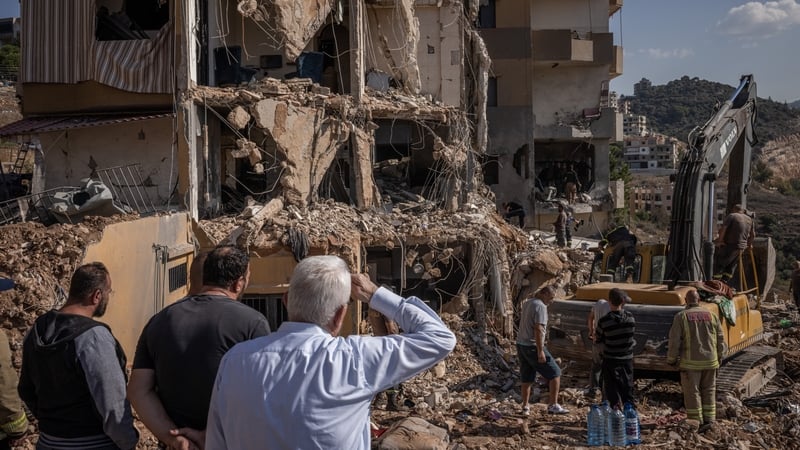 Emergency workers look for bodies in the rubble after the Israeli strike on Barja in Lebanon