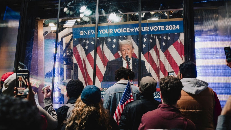 Supporters watch a broadcast of Donald Trump addressing his election night watch party