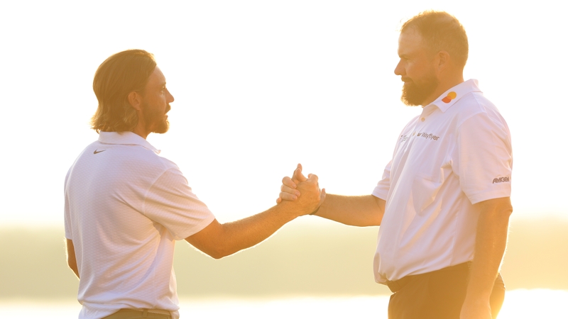Tommy Fleetwood (L) is congratulated by Shane Lowry at Yas Links Golf Course