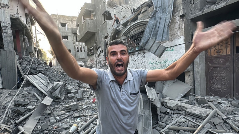 A Palestinian man reacts as he stands amid the rubble, following an Israeli strike on the Jabalia refugee camp