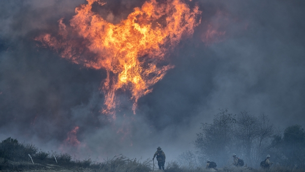 Firefighters tackle the Mountain Fire near South Mountain Road in Fillmore, California