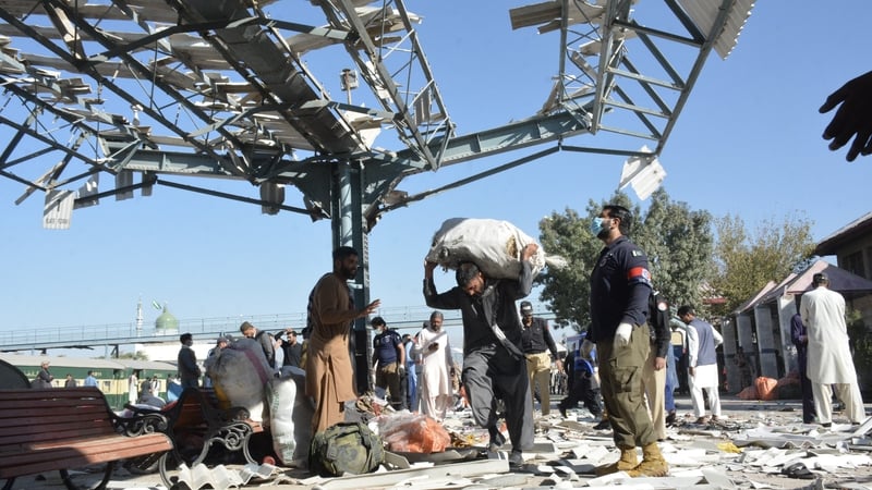 Security forces investigate the area after a bomb explosion at Quetta city railway station