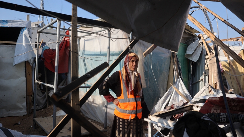 A displaced Palestinian woman stands amid destroyed shelters following an Israeli strike in in Deir el-Balah in central Gaza