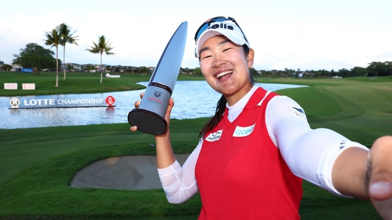 A Lim Kim poses with her trophy after triumphing at the Lotte Championship