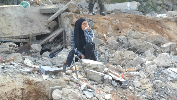 A woman mourns she looks on at rubble of where an Israeli airstrike hit in Ain Yaaqoub, Lebanon