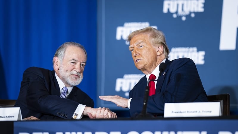 Mike Huckabee speaks with Donald Trump at an event in Delaware while on the campaign trail earlier this year