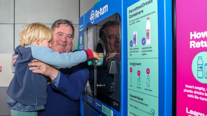 Lord Mayor of Cork Dan Boyle uses one of the vending machines with the help of a young passenger