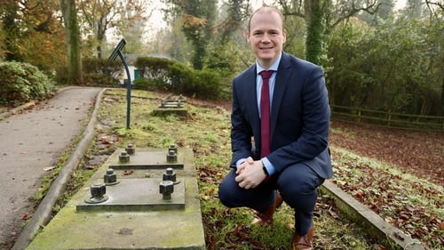 NI Communities Minister Gordon Lyons at barrage balloon anchors on the Stormont Estate