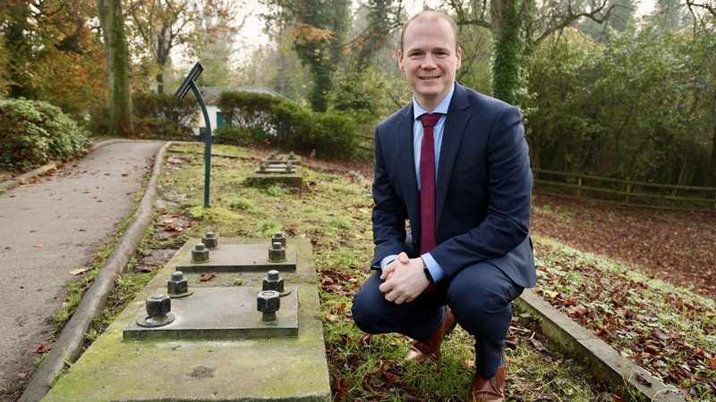 NI Communities Minister Gordon Lyons at barrage balloon anchors on the Stormont Estate