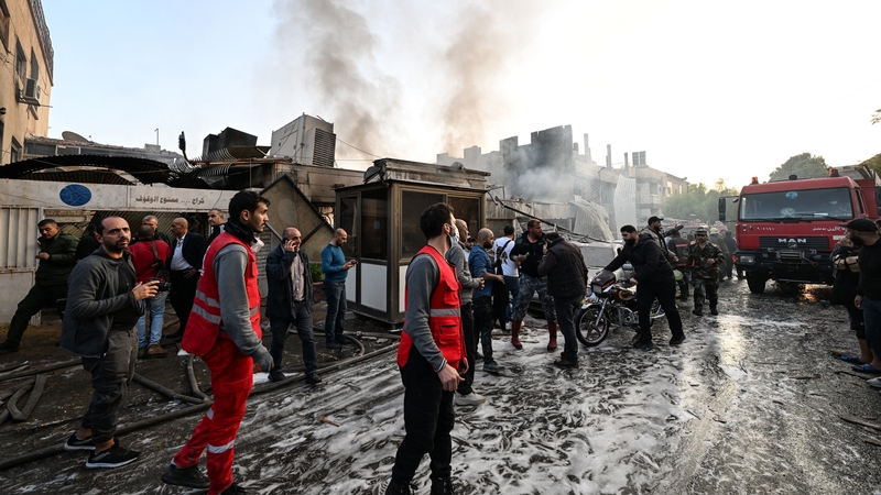 People check the damage following a reported Israeli strike in the Mazzeh district of Damascus