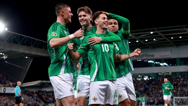 Dion Charles is congratulated by his Northern Ireland team-mates after scoring from the penalty spot