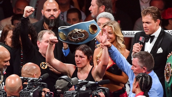 Katie Taylor celebrates after retaining her belts