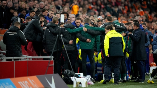 Staff members of Hungary huddle together during the medical emergency treatment of Adam Szalai