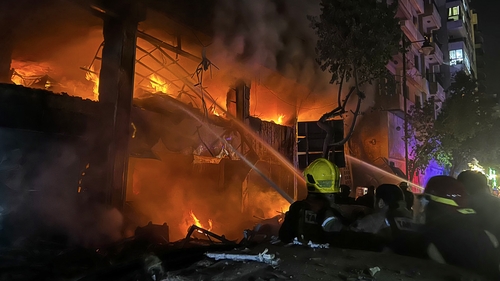 Lebanese firefighters douse the flames at the site of an Israeli strike that targeted a building in Beirut's Mar Elias street
