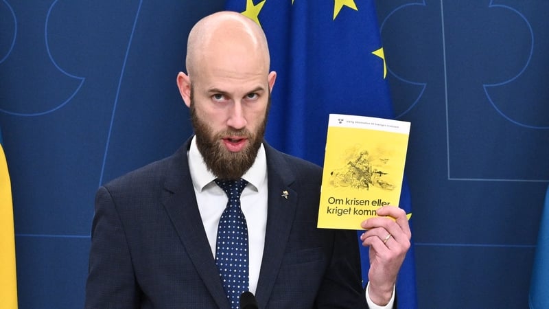 Sweden's Minister for Civil Defence Carl-Oskar Bohlin the booklet 'If Crisis or War Comes' that will be sent to all households