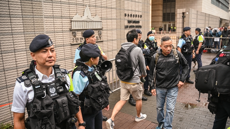 Police keep watch outside the West Kowloon Magistrates' Court in Hong Kong on 19 November