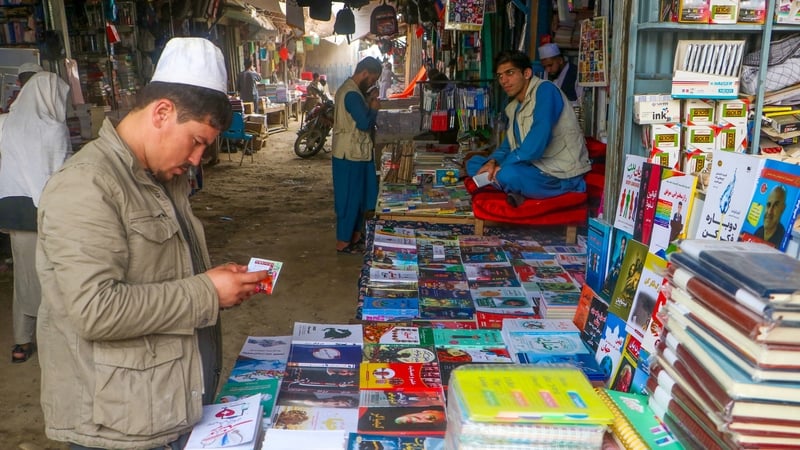 Afghan men at bookshops along a street in Taloqan, the capital of the Takhar province, checking imported books earlier this month