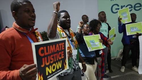 Climate activists outside the talks venue in Azerbaijan's capital Baku