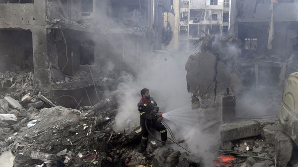 Civil defense teams conduct debris removal and search and rescue operations after an Israeli attack destroyed an eight-storey building in Beirut