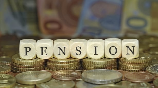 a stack of coins against a background of euro notes with dice spelling out the word pension
