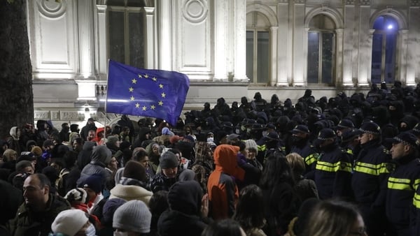 Thousands of Georgian protesters gather outside the parliament building to oppose the government's decision to delay European Union accession negotiations until 2028