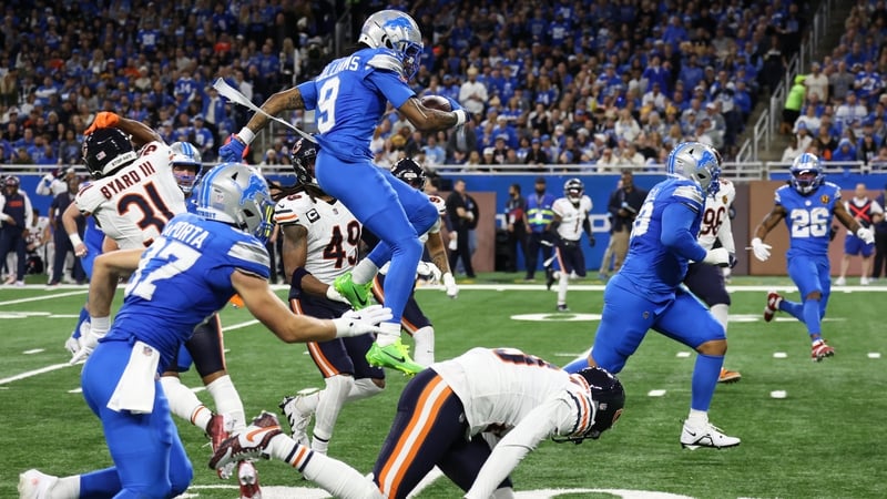Detroit Lions wide receiver Jameson Williams hurdles Chicago defenders