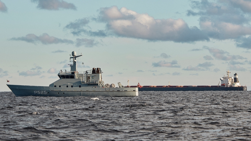 Suspicions have been directed at a Chinese ship, the Yi Peng 3 (R), which is pictured being monitored by a Danish naval patrol vessel in the sea of Kattegat