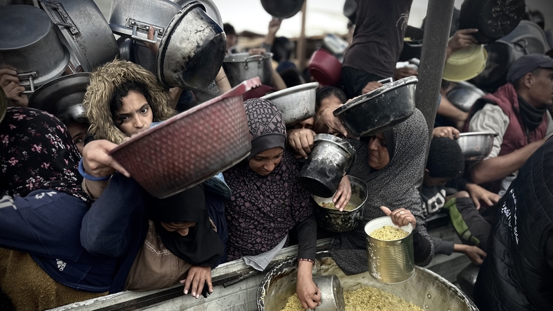 Palestinians in Khan Yunis gather at a food distribution site in the south of Gaza