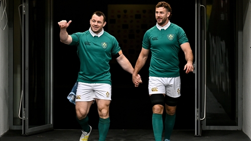 Cian Healy (l) is led onto the Aviva Stadium pitch by Caelan Doris (r) at Ireland's captain's run