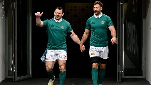 Cian Healy (l) is led onto the Aviva Stadium pitch by Caelan Doris (r) at Ireland's captain's run