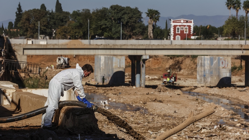 A worker cleans up mud in Paiporta, Valencia