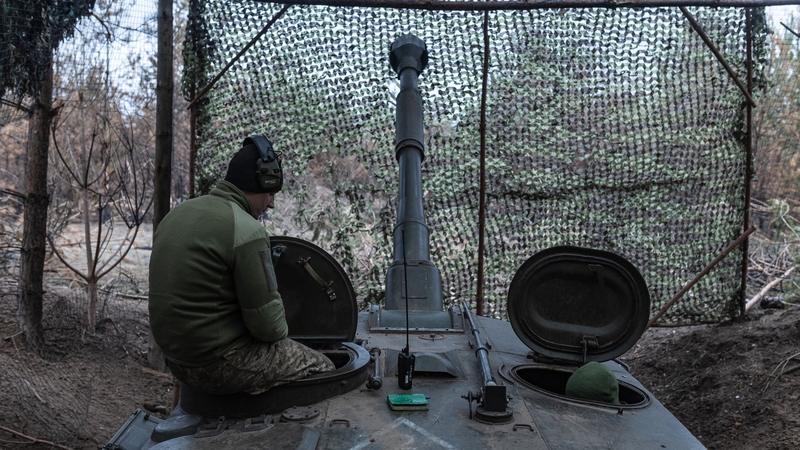 A Ukrainian soldier waits for orders while stationed at a self-propelled artillery in the direction of Kreminna, Donetsk Oblast, Ukraine