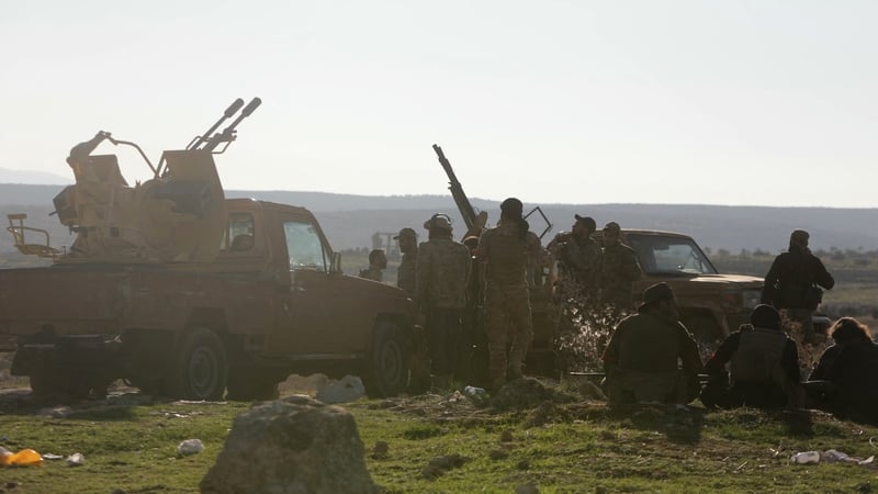 Anti-government fighters take a position near the northern Syrian town of Tal Rifaat