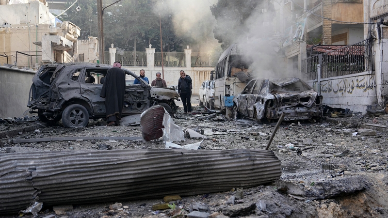 People check the damage at the scene of a pro-regime forces strike that targeted a neighbourhood in Syria's rebel-held city of Idlib