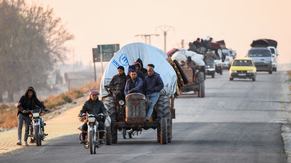 Displaced Syrians drive their vehicles loaded with belongings on the Aleppo-Raqqa highway