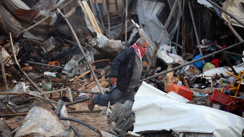 A Palestinian man inspects the damage in the aftermath of an Israeli strike on a tent camp in Khan Younis