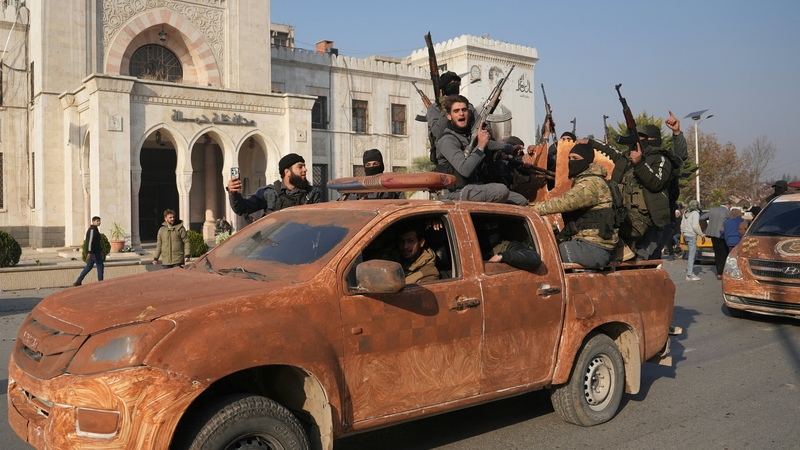 Syrian anti-government fighters celebrate as they pour into the captured central-west city of Hama