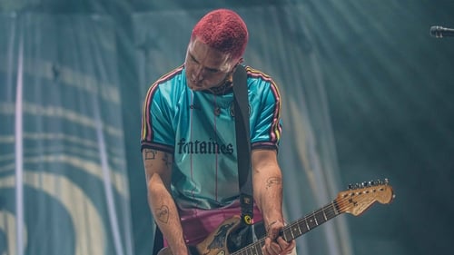 Wear your club jersey to work day: Carlos O'Connell from Fontaines D.C. togs out in the Bohs jersey at Dublin's 3 Arena last December. Photo: Leah Carroll