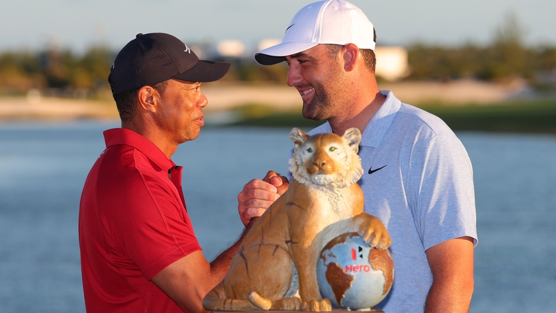 Tournament host Tiger woods congratulates Scheffler on his win