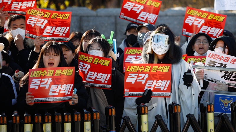Tens of thousands gather across from the National Assembly in Seoul holding signs that read 'Impeach Yoon Suk Yeol, leader of treason, immediately'