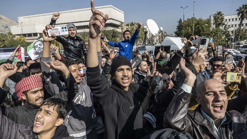 People celebrate the collapse of 61 years of Baath Party rule