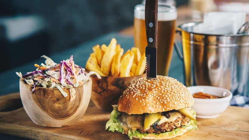 A bar manager is challenging his dismissal from a hotel after management said he was 'defrauding customers' by adding 10% to the bills of smaller tables that it would not normally ask to pay a service charge