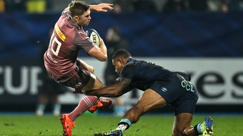 Jack Crowley of Munster is tackled by Andrea Cocagi