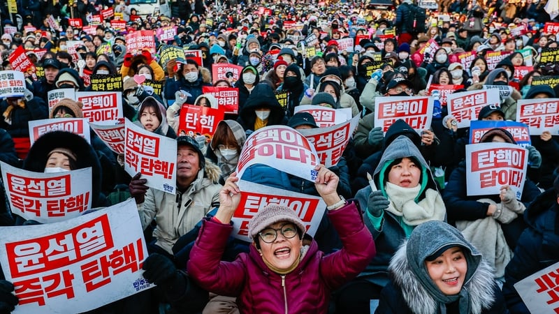The vote took place as hundreds of thousands took to the streets of Seoul